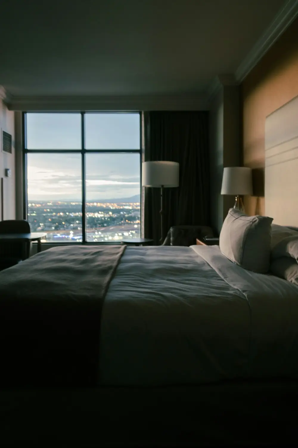 Hotel room with a view over the city at dusk