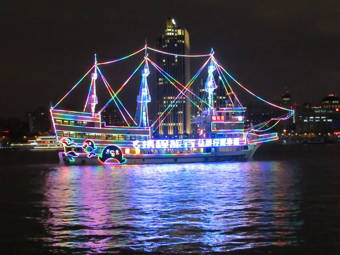Lit-up sailing boat on the Huangpu River at night